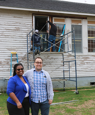 Drs. Melissa Stuckey and Charles Reed outside the Rosenwald School at ECSU