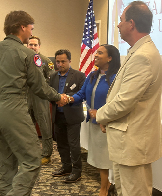 ECSU Chancellor Karrie G. Dixon congratulates a Flight Academy student