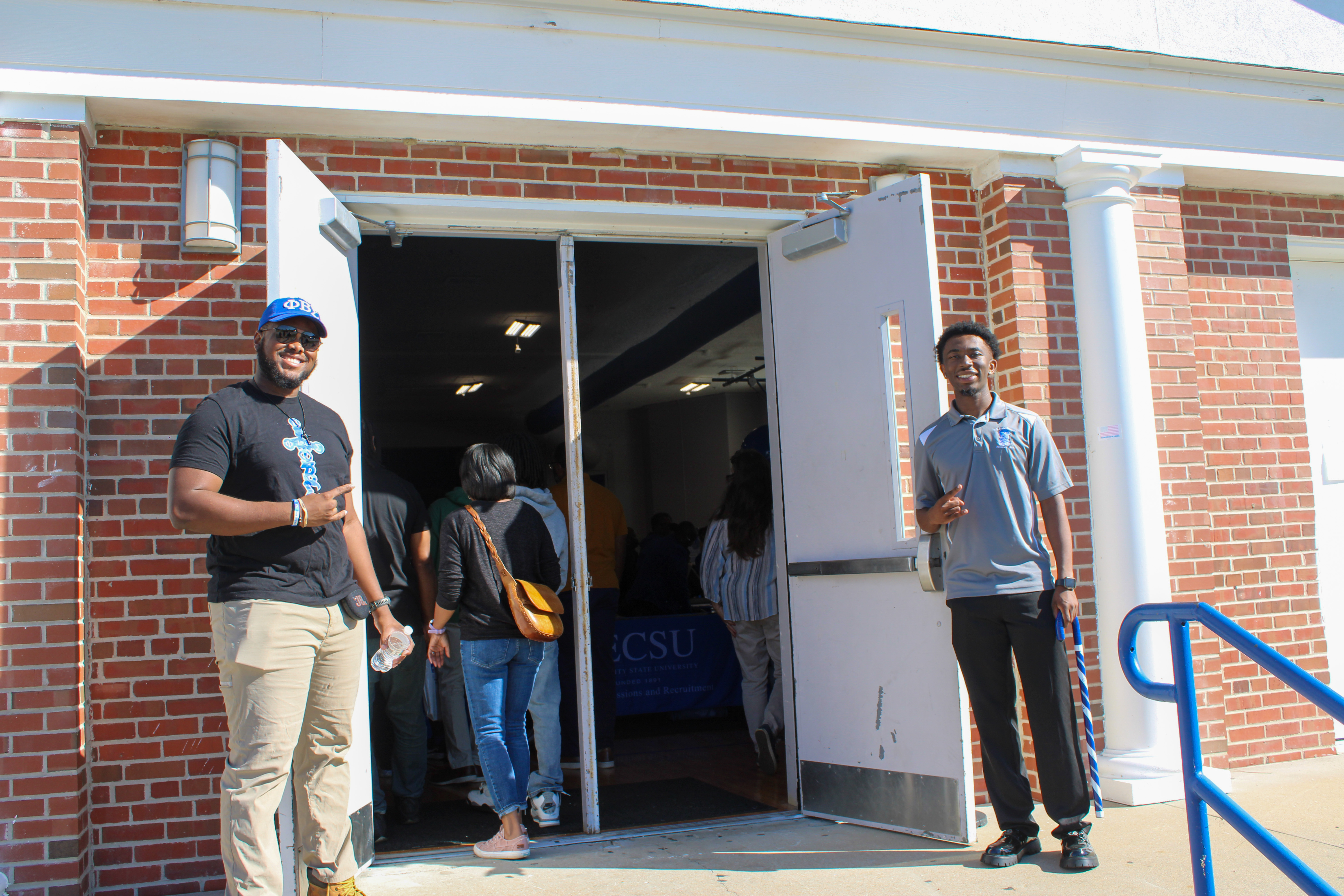 Student leaders welcoming visitors to Open House at the doors
