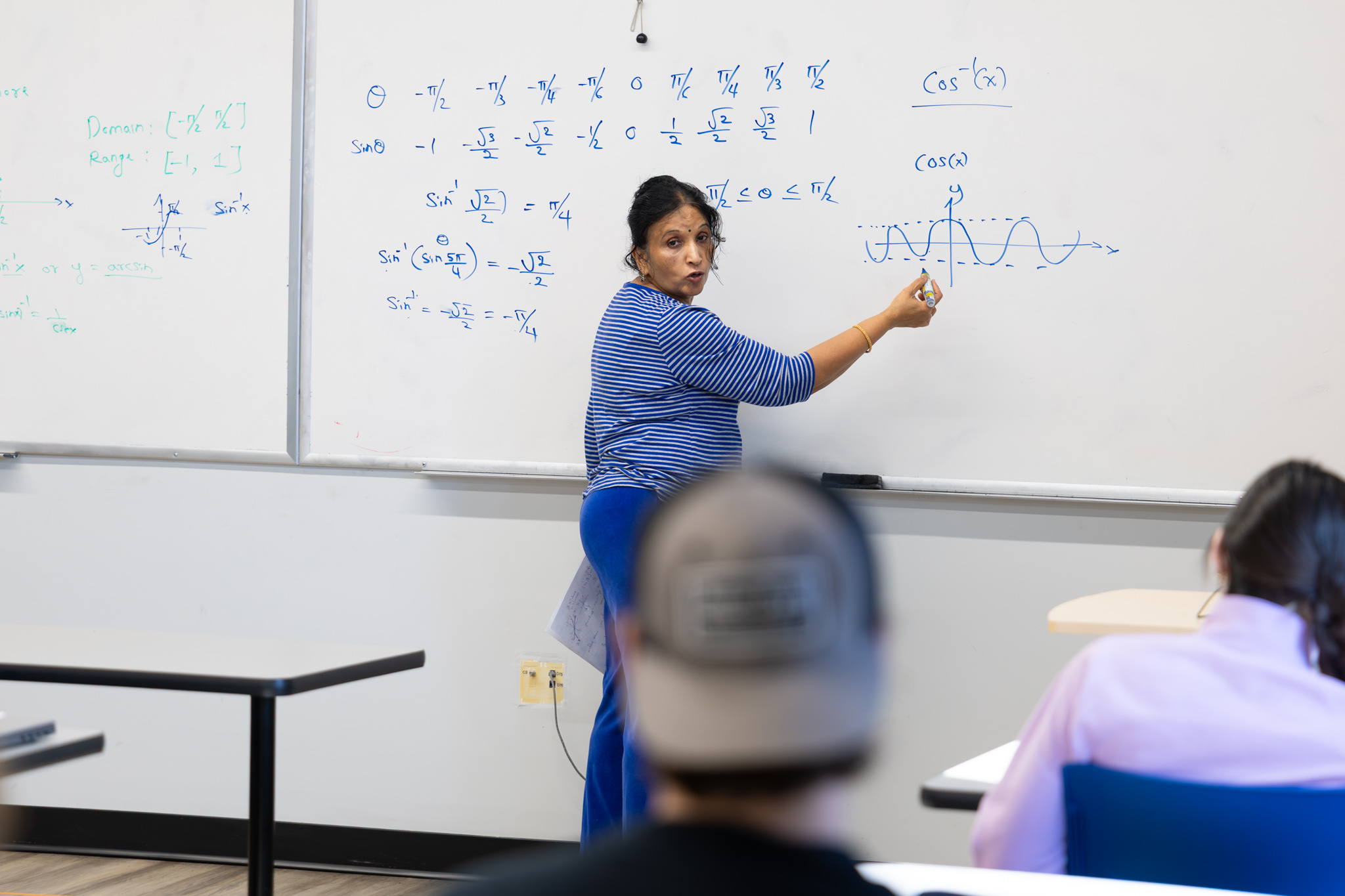 Professor in front of class teaching mathematics