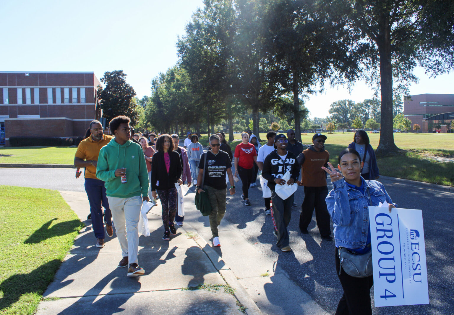 Tour guide leading prospective students and guests around campus at Open House