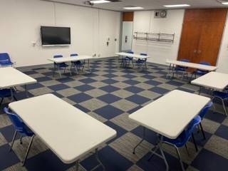 Wide shot of the front of room 130 of the K.E. White Graduate Center.