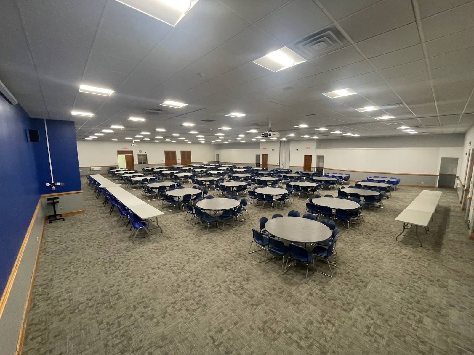 Wide shot of the full ballroom in K.E. White Graduate Center with tables and chairs laid out.